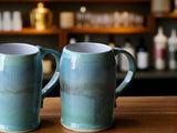 Handmade ceramic beer stein with green and blue glaze