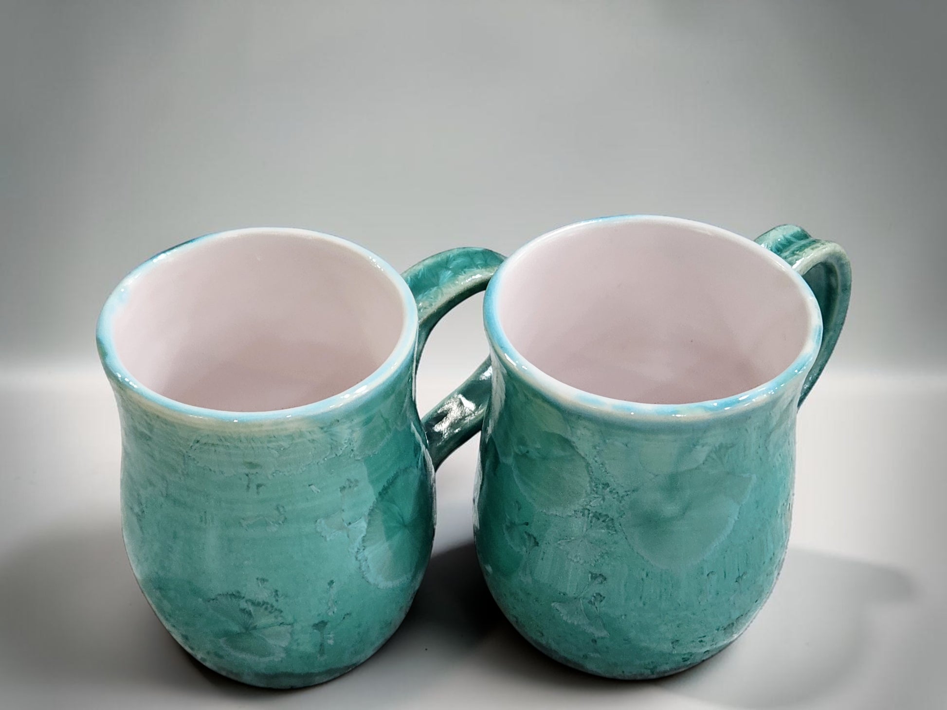 Handmade 350 ml porcelain coffee mug with green crystalline glaze