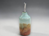 Pottery olive oil bottle with pouring spout in green and brown tones