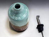 Unique ceramic oil dispenser with green glaze and rustic brown base