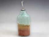 Handmade pottery oil bottle styled in a kitchen lifestyle setting