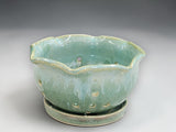 Handmade ceramic colander bowl in soft green glaze