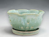Green handmade pottery bowl for washing and serving berries