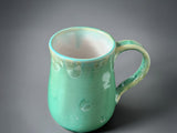 Handmade pottery mug in soft green crystalline glaze