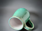 Artisan stoneware mug with pale green crystalline glaze