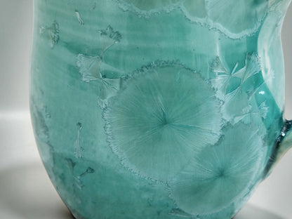 Close-up of naturally formed crystals in a green porcelain glaze