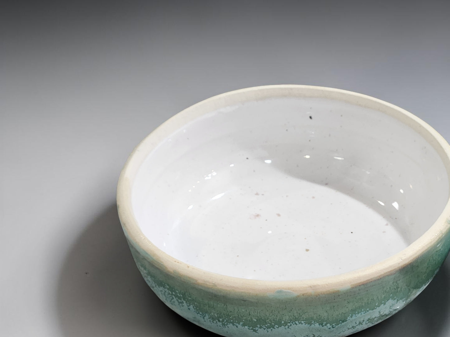 Wheel-thrown ceramic bowl with green glaze