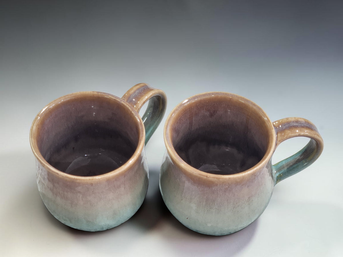 Artisan pottery mug handcrafted in Melbourne featuring unique earthy brown and soft green glaze transitions