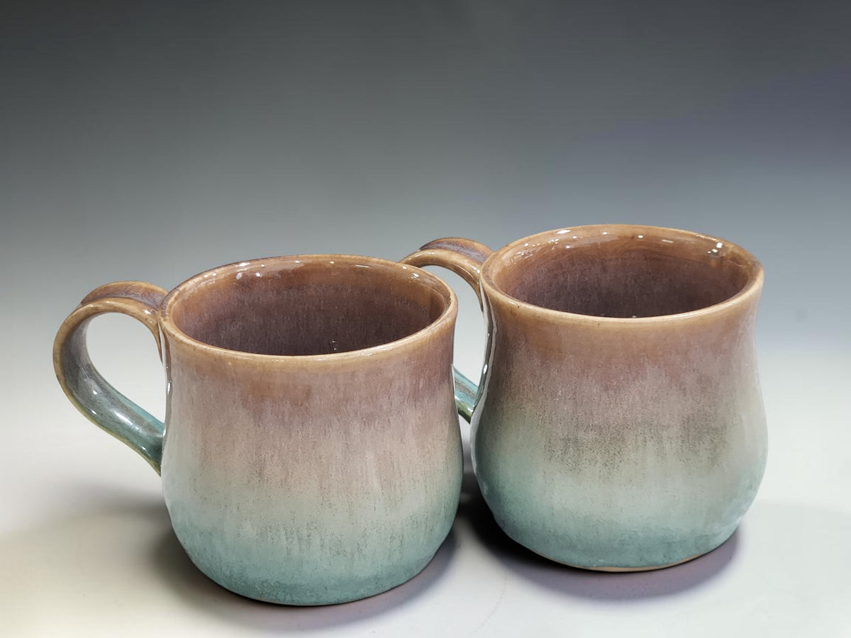 Handmade pottery coffee mug in layered brown and green glazes showcasing one-of-a-kind ceramic craftsmanship.