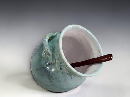 Green ceramic salt cellar with wide opening and rear loop handle
