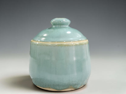 Seafoam green pottery sugar bowl with cream interior and handmade ceramic lid