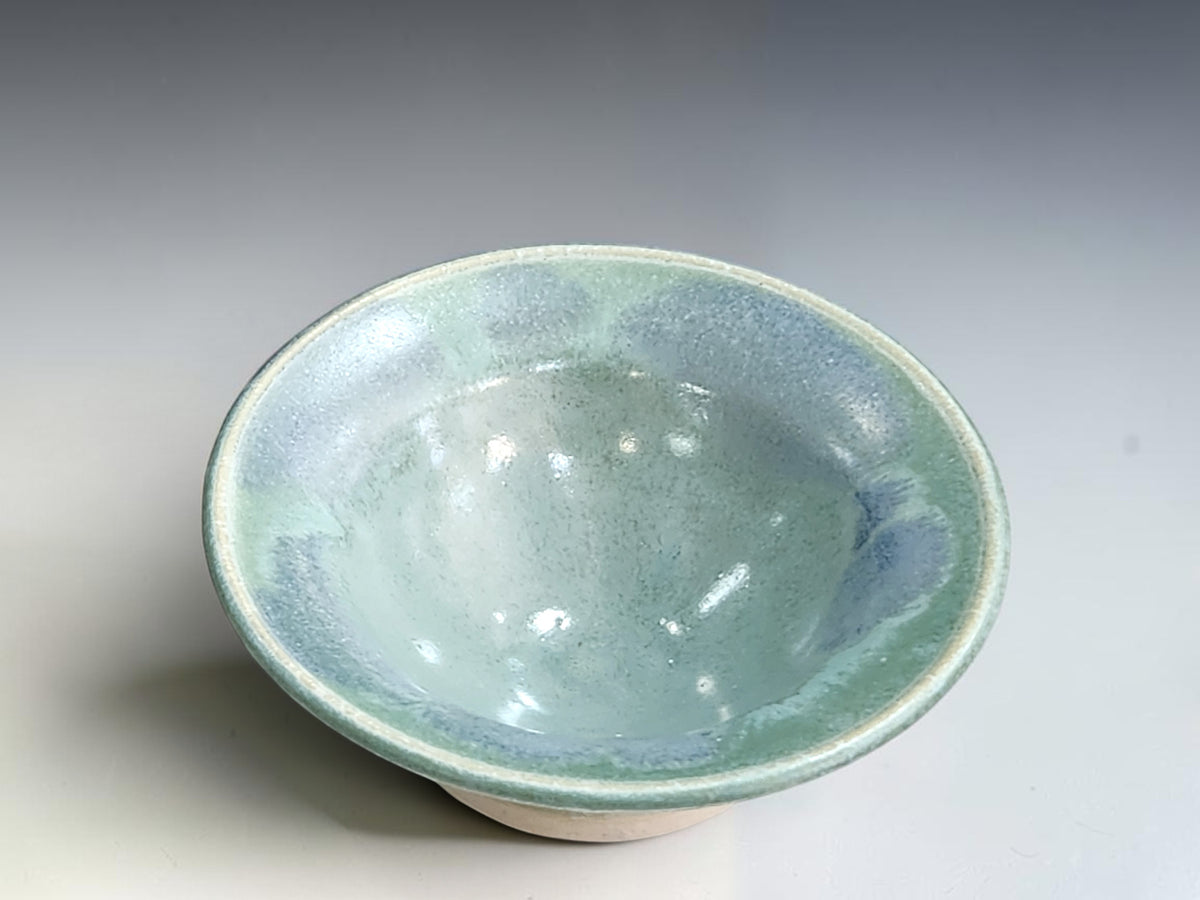 Handcrafted trinket bowl measuring 10cm wide and 4cm high with a cream-edged rim.