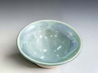 Handcrafted trinket bowl measuring 10cm wide and 4cm high with a cream-edged rim.