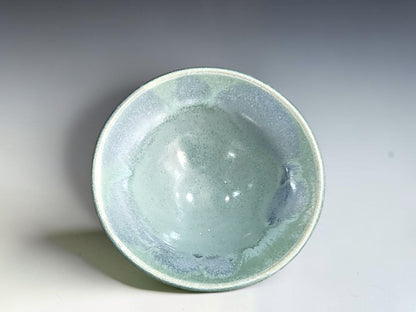 Seafoam green pottery ring dish with a cream foot and gently flared sides
