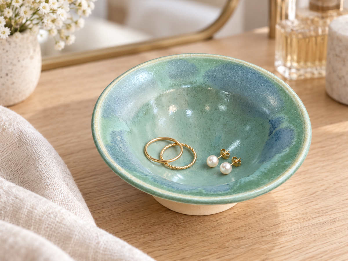 Buxton Pottery trinket bowl styled with delicate jewellery beside soft ivory linen.
