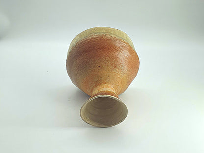 Ceramic dessert bowl with asymmetrical rim and raised base