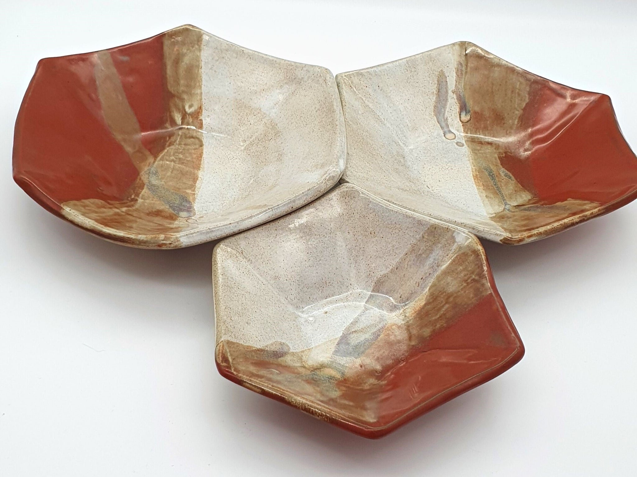 Set of 3 handmade ceramic serving bowls. Hexagon shaped in a cream and red glaze.