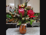 Handmade porcelain vase with vivid blue crystalline glaze on orange