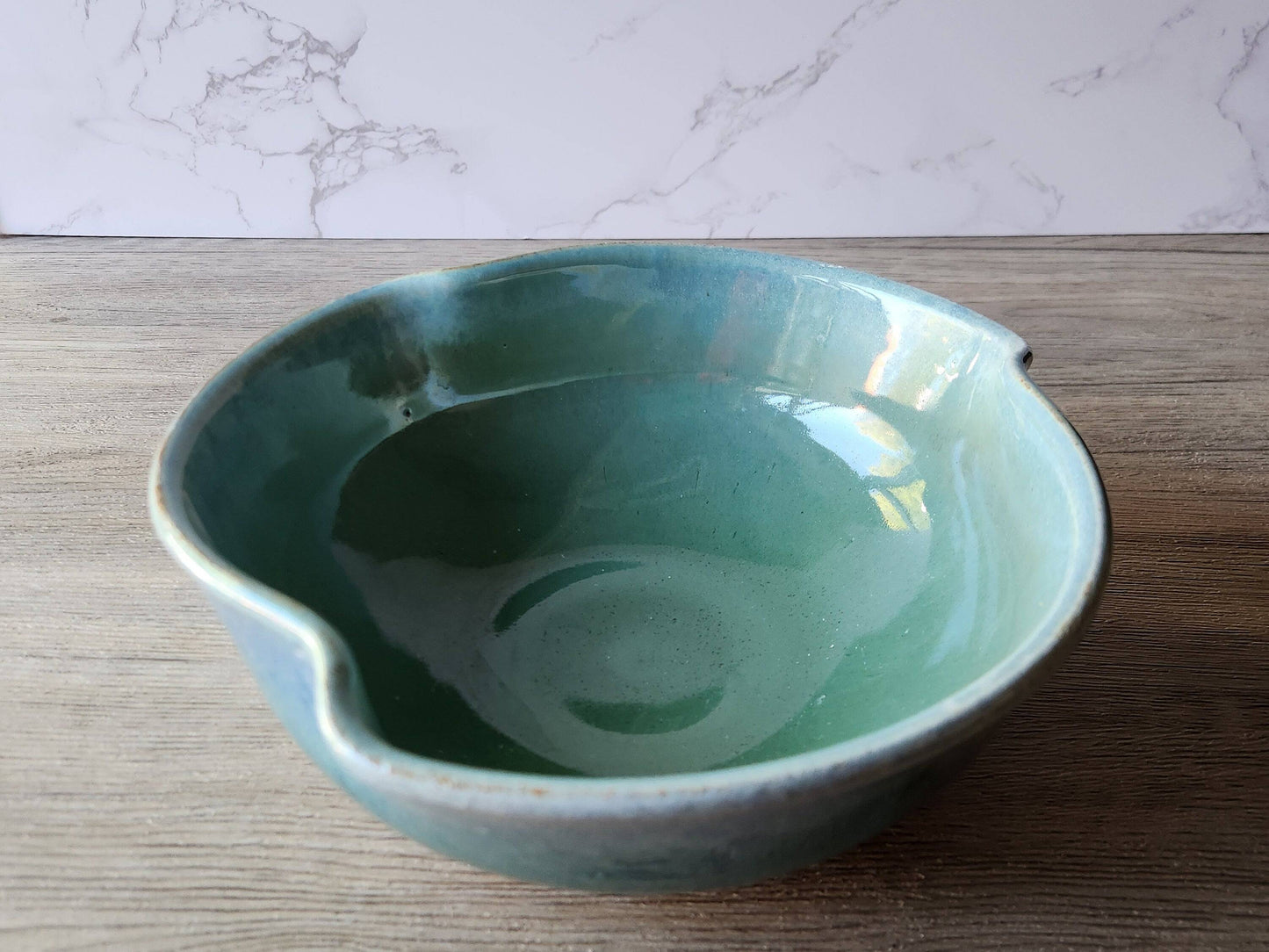 Handmade pottery serving bowl with green glaze