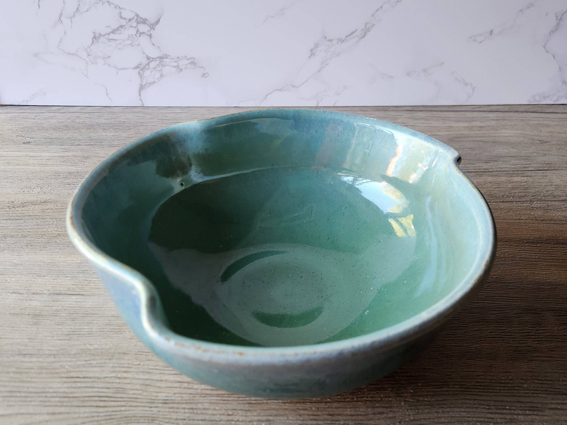 Handmade pottery serving bowl with green glaze