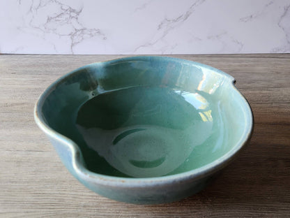 Handmade pottery serving bowl with green glaze