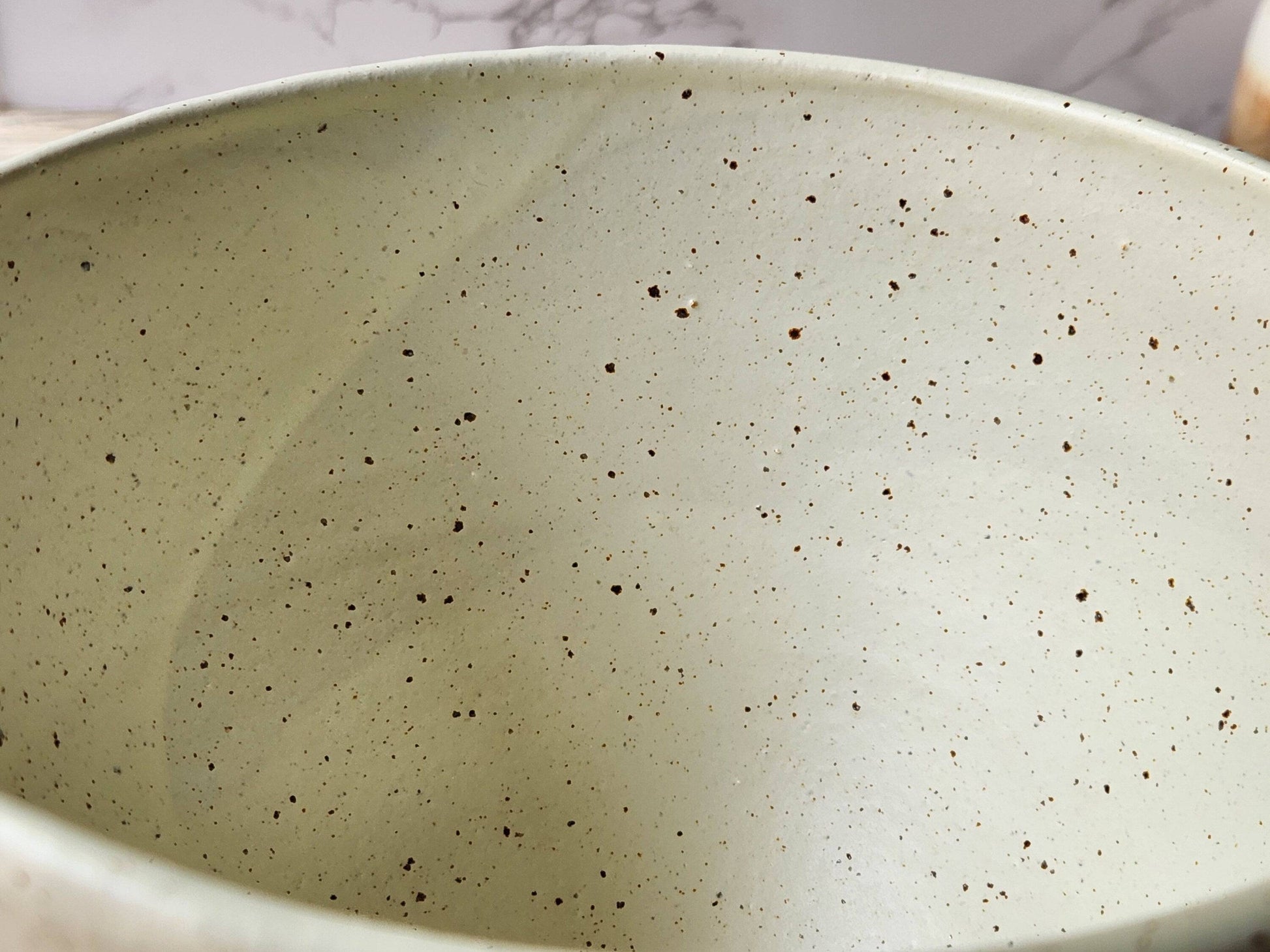 Handmade ceramic bowl with glossy  speckled cream interior