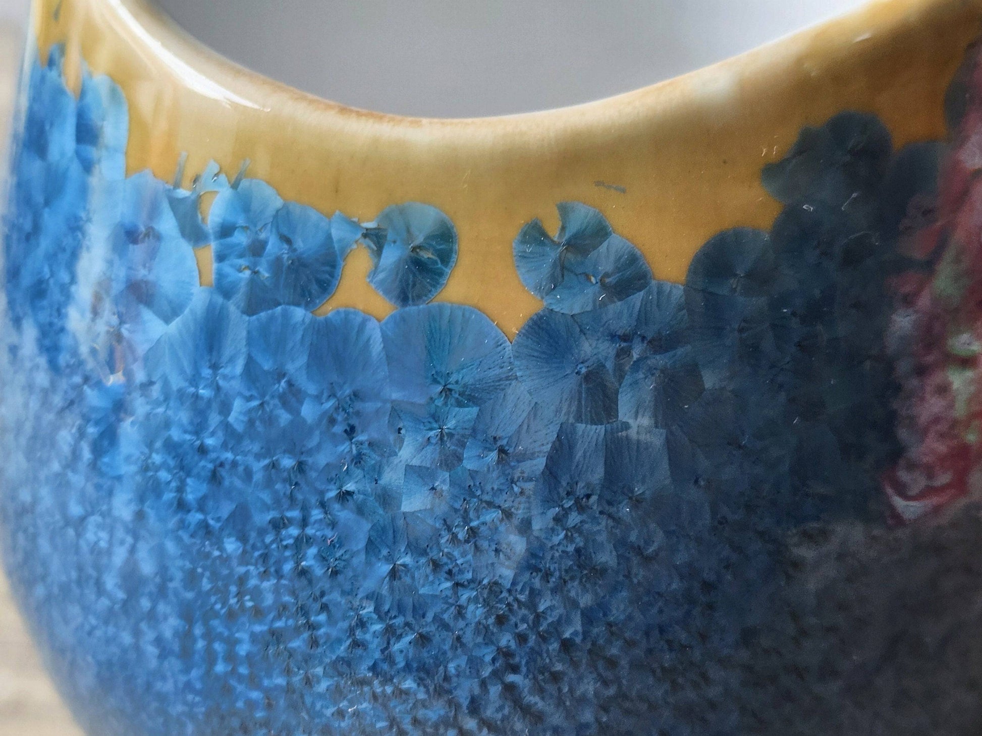Close up of Ceramic entryway display bowl with blue and orange crystals