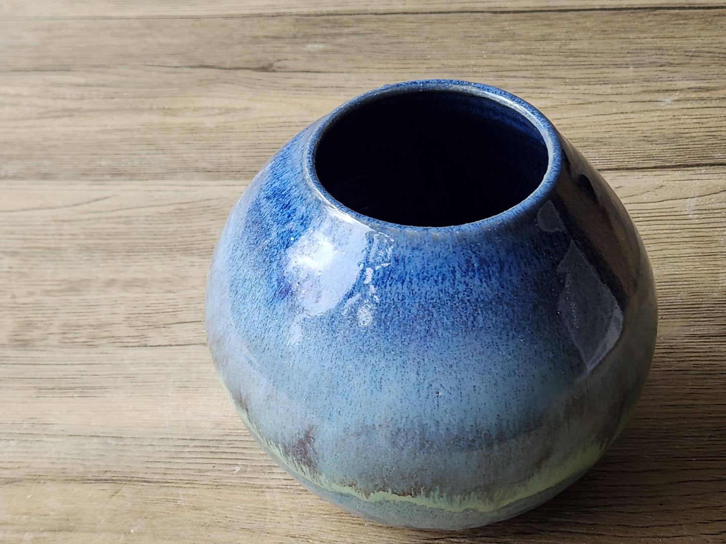 Close-up of wheel-thrown moon jar rim showing the mottled blue glaze finish