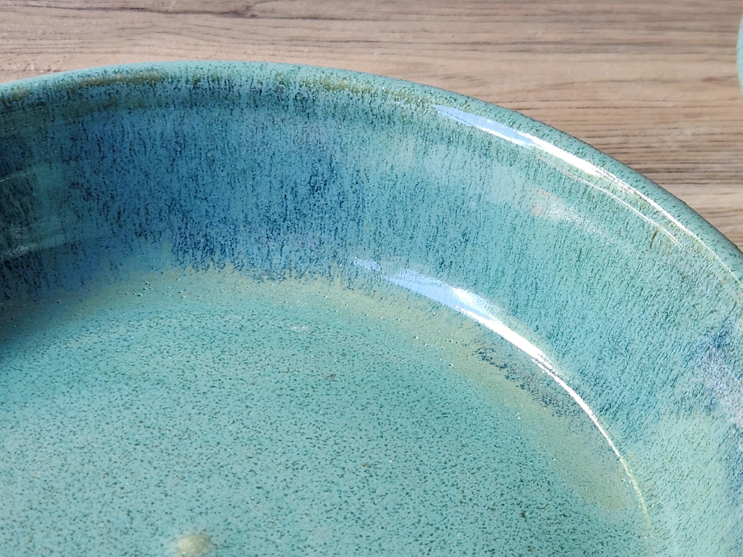 Close up of glaze on a Unique blue and green pottery serving dish