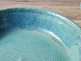 Close up of glaze on a Unique blue and green pottery serving dish