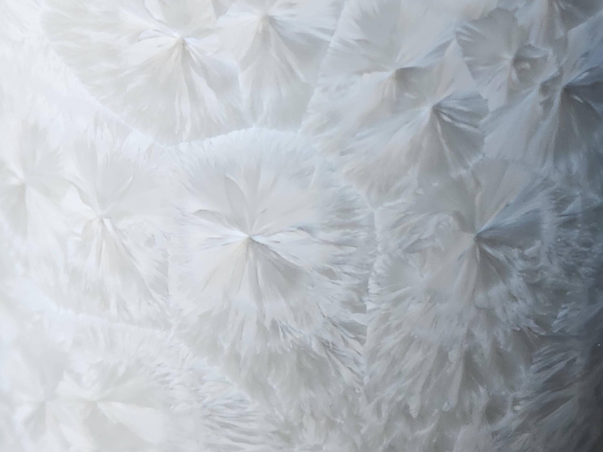 Close-up of crystals on the Minimalist white crystalline pottery cup or tumbler