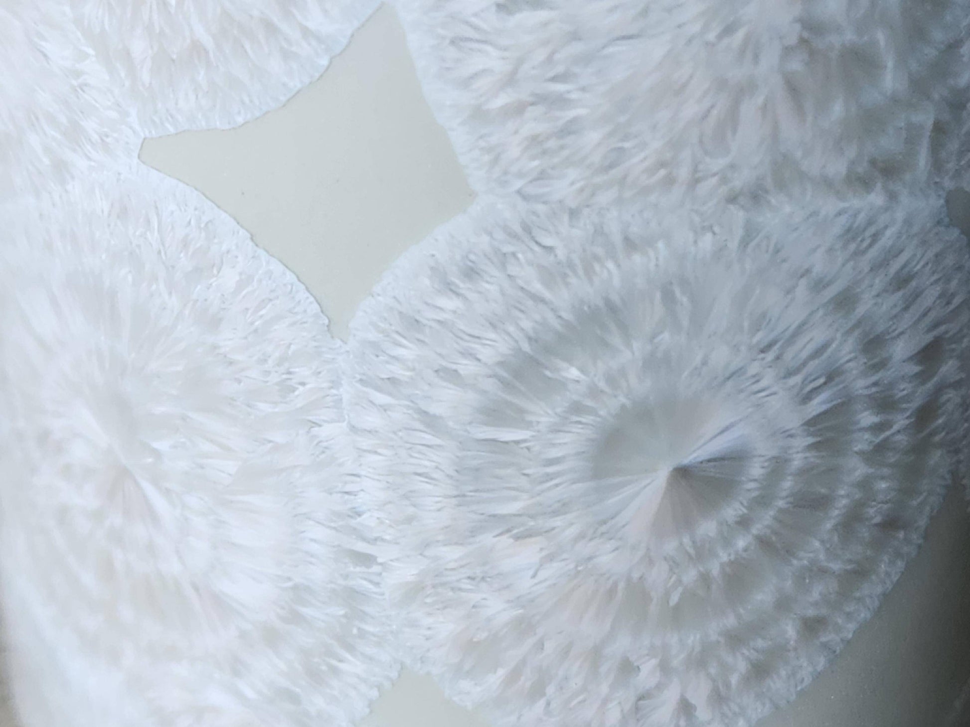 Close up of the flower-like crystal on One-of-a-kind white crystalline pottery tumbler – handmade in Australia