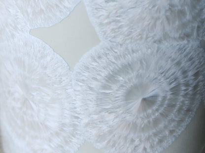 Close up of the flower-like crystal on One-of-a-kind white crystalline pottery tumbler – handmade in Australia