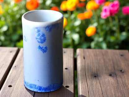Glossy blue-on-blue ceramic vase with lace-like crystal patterns