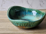 Large pottery fruit bowl with mottled green blue glaze