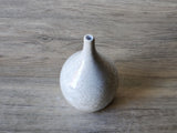 Porcelain bud vase with rounded belly and crystalline detail