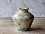 Artisan pottery vase with cream glaze and soft mint crystals