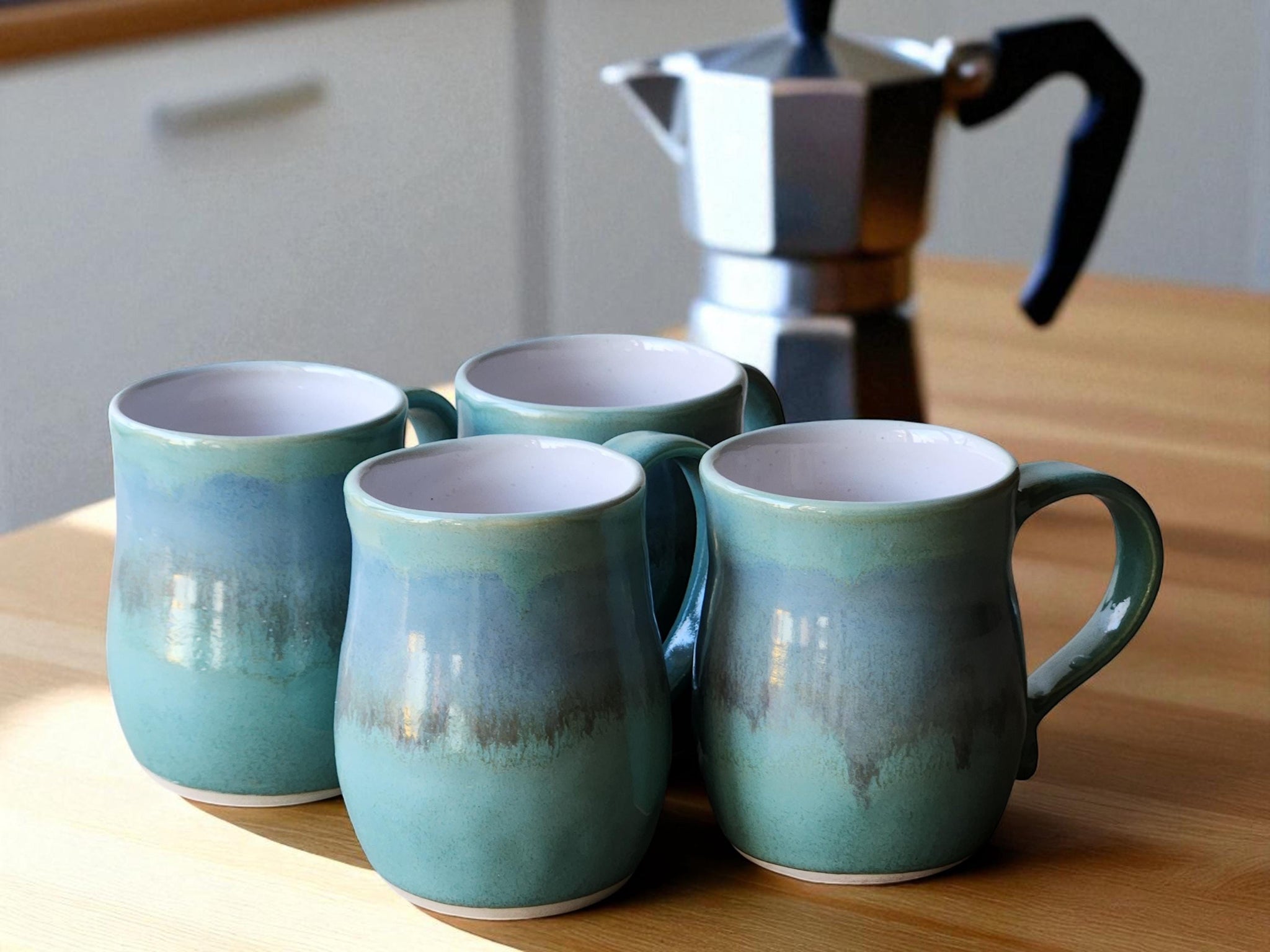 Handmade ceramic mug in blue-green glaze with white interior – 400ml