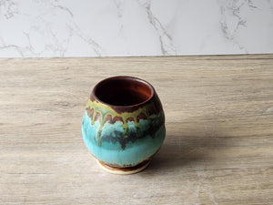 Wheel-thrown pottery tea cup with layered rustic glazes