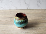 Wheel-thrown pottery tea cup with layered rustic glazes