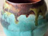Close up of the glaze on the Handmade rustic yunomi tea cup with turquoise and brown glaze