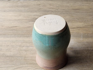 Comfortable handle pottery mug with glossy brown rim and green glaze