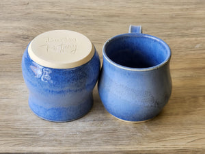 Blue handmade pottery mug with rounded comfort shape