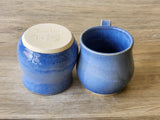 Blue handmade pottery mug with rounded comfort shape