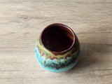 inside view of Artisan stoneware yunomi with turquoise drip glaze