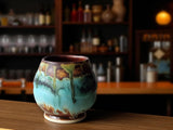 Handmade rustic yunomi tea cup with turquoise and brown glaze