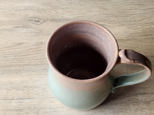 Handmade ceramic coffee mug with earthy brown and spearmint tones
