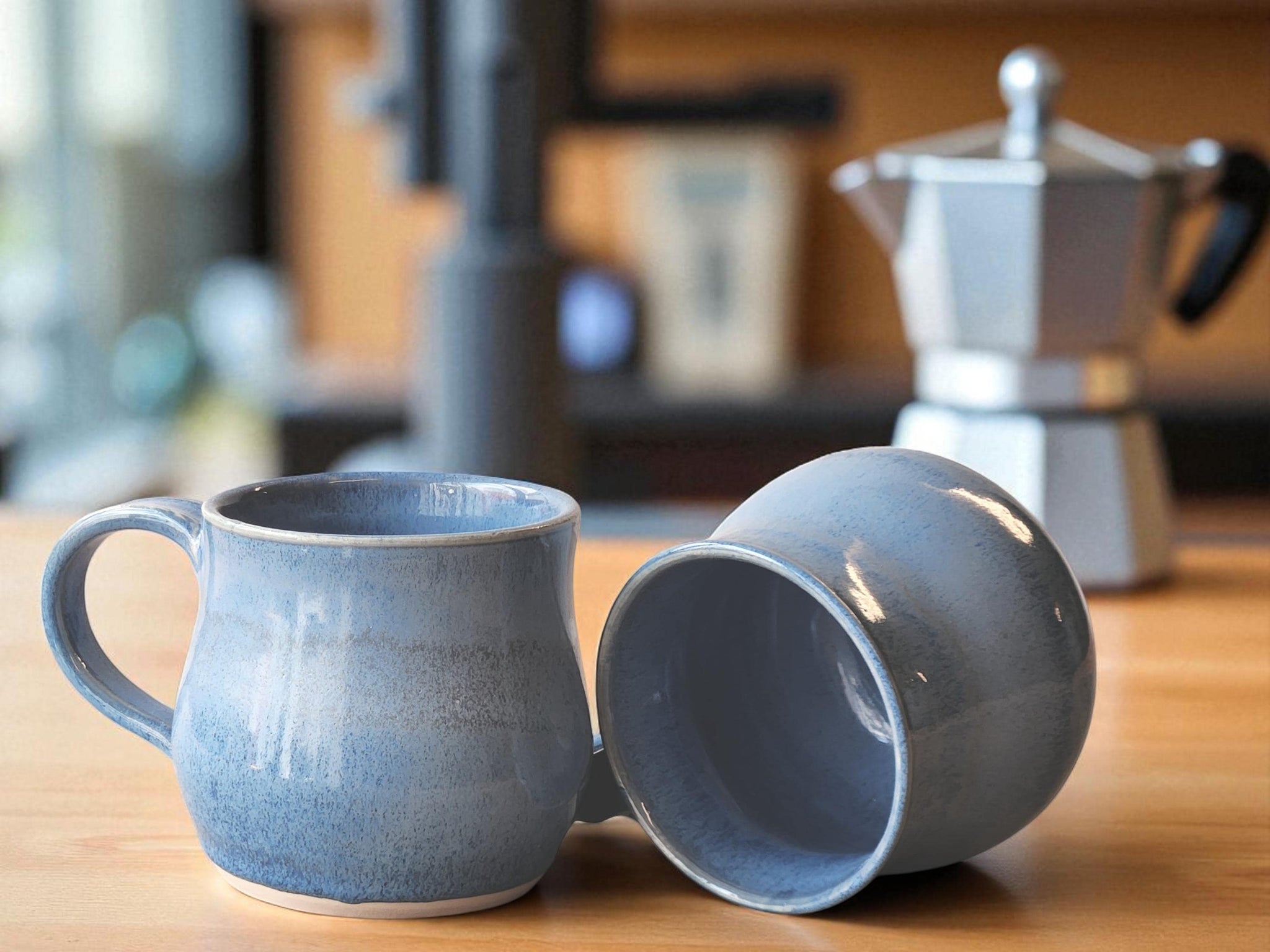 Handmade blue ceramic coffee mug with mottled glaze