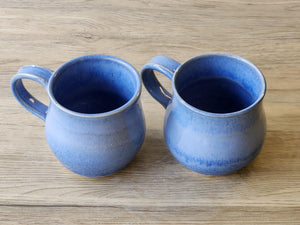 Rustic handmade ceramic mug with glossy blue finish