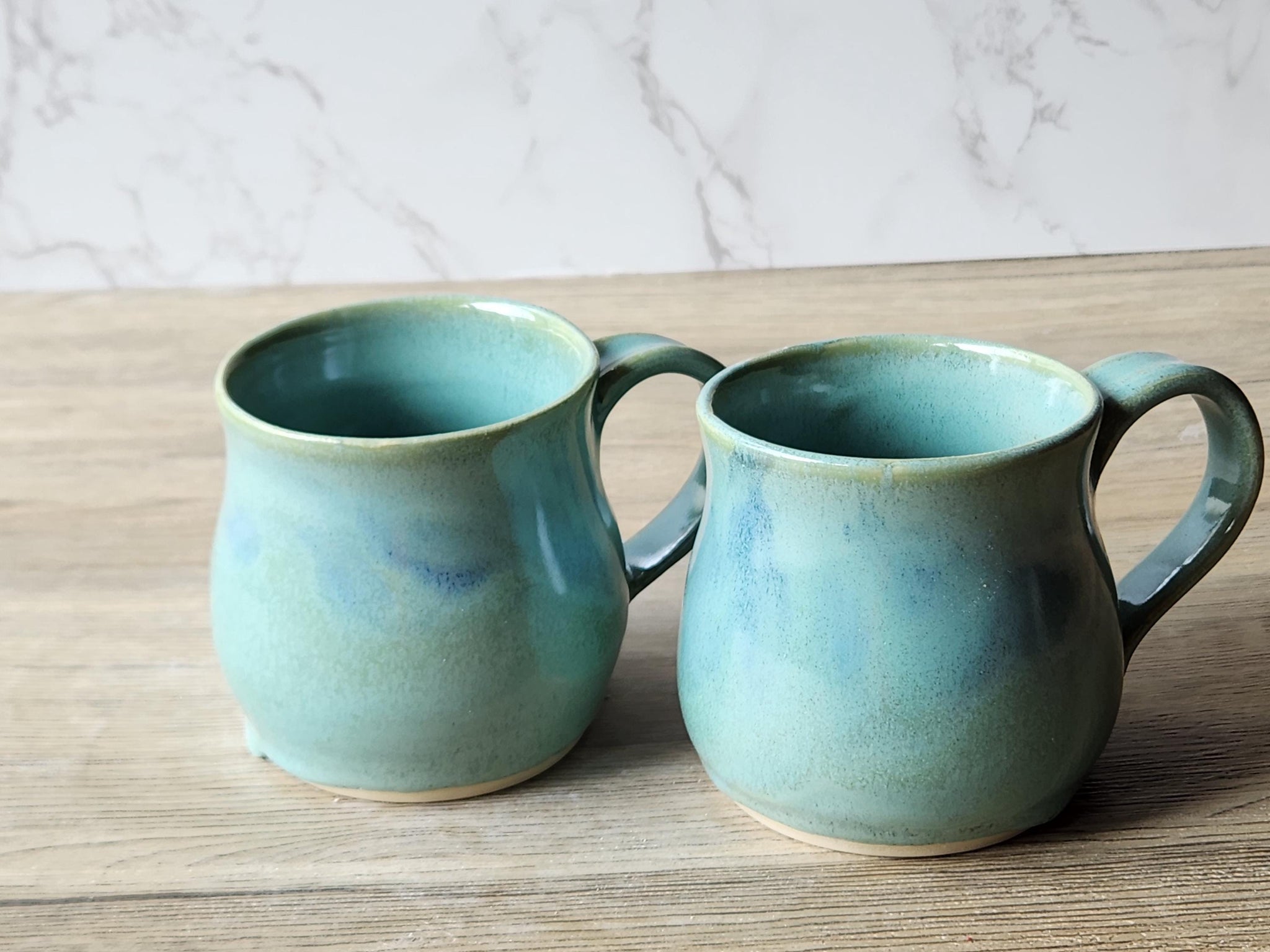 Wheel-thrown ceramic mug with soft blue mottling